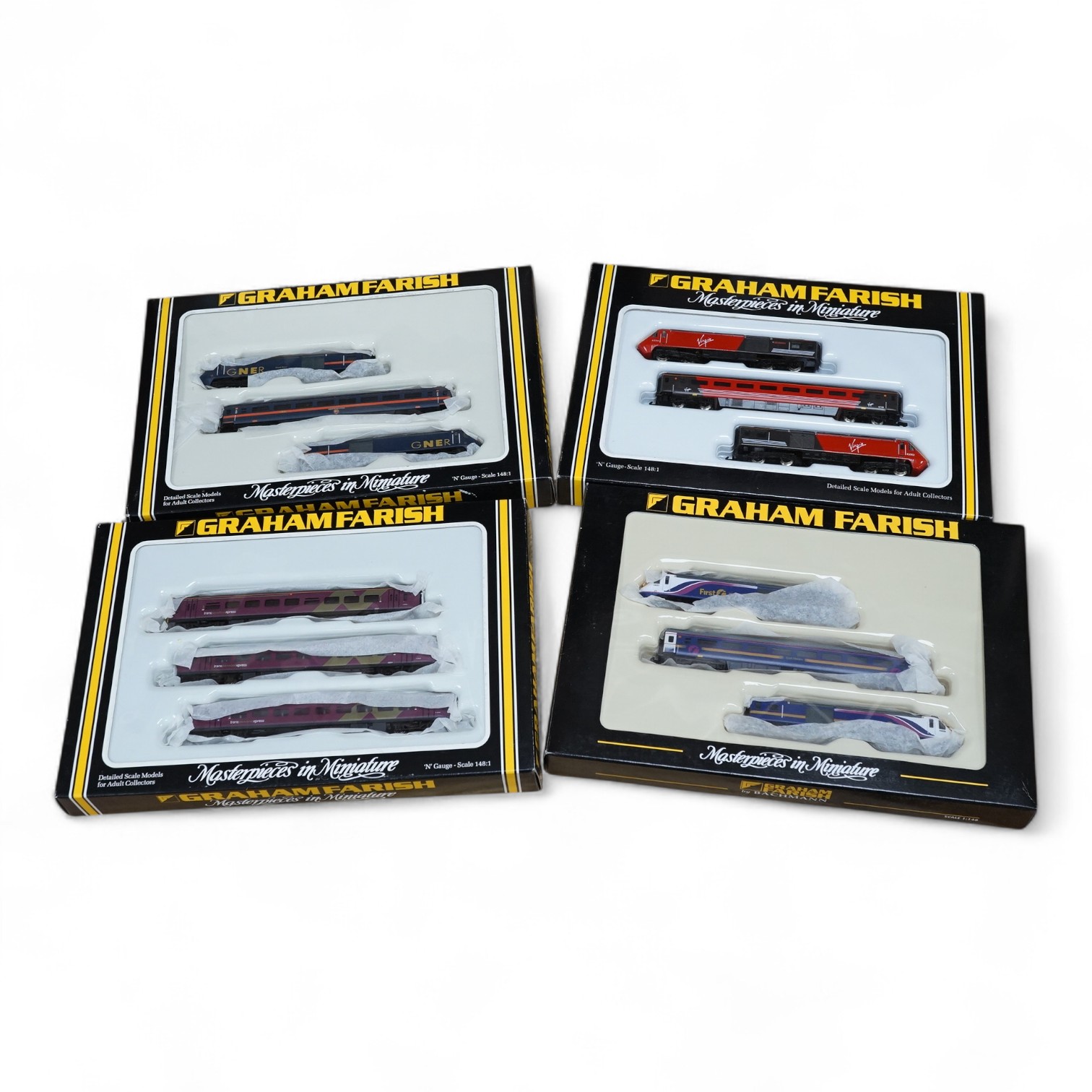 Four boxed Graham Farish N gauge railway train packs; a Virgin Trains HST 124 train (8128), a First Great Western HST 125 train (371477), a Northern Sprite 3-car DMU (371525) and a GNER HST 125 train (371476). Condition